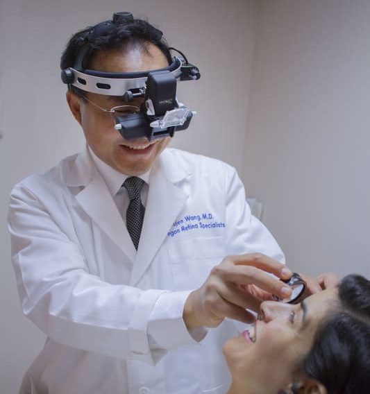 Dr. Wang treating a woman's eyes
